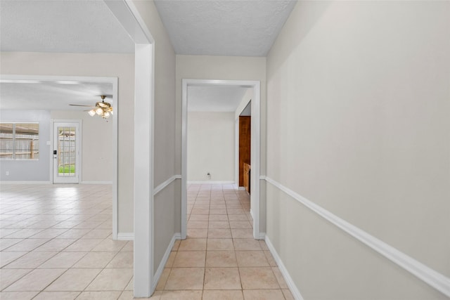 1102 Brenda Dr, Deer Park, TX 77536 - corridor with light tile patterned floors, a textured ceiling, and baseboards