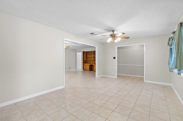 1102 Brenda Dr, Deer Park, TX 77536 - spare room with ceiling fan, baseboards, light tile patterned flooring, and a textured ceiling