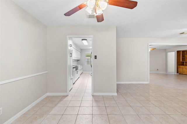 1102 Brenda Dr, Deer Park, TX 77536 - spare room with a ceiling fan, light tile patterned floors, and baseboards