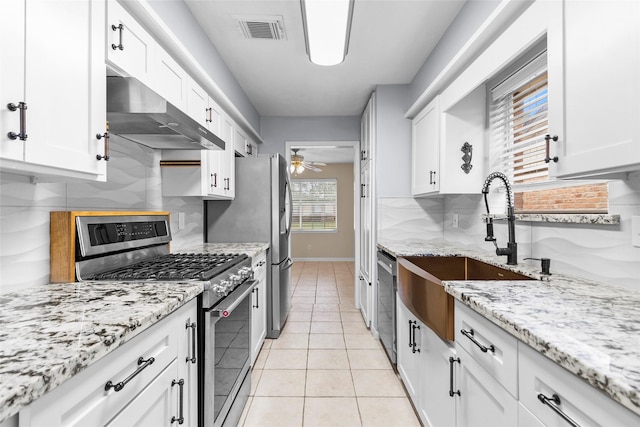 1102 Brenda Dr, Deer Park, TX 77536 - kitchen with stainless steel appliances, under cabinet range hood, decorative backsplash, and a sink