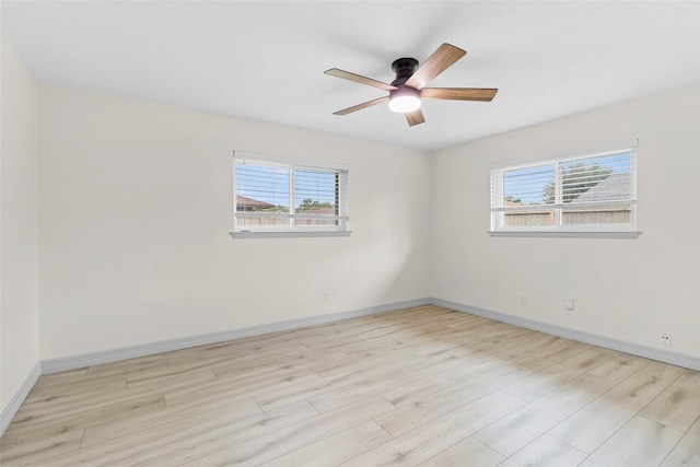 1102 Brenda Dr, Deer Park, TX 77536 - unfurnished room featuring plenty of natural light, baseboards, ceiling fan, and light wood-style floors
