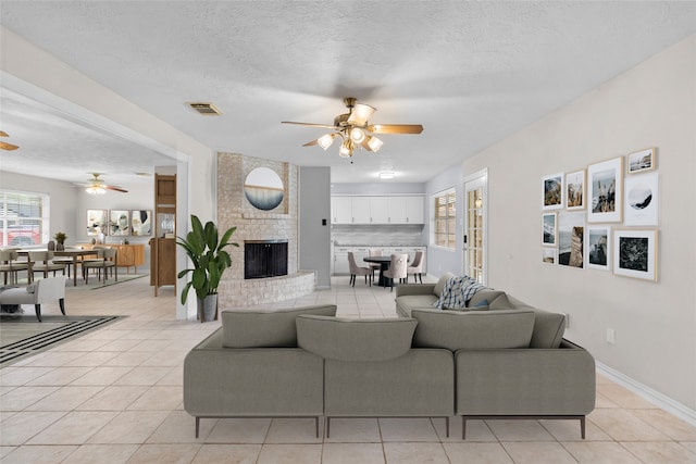 1102 Brenda Dr, Deer Park, TX 77536 - living area featuring ceiling fan, light tile patterned floors, plenty of natural light, and a textured ceiling
