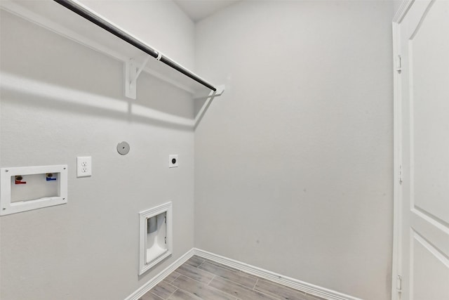25707 Hickory Pecan Trl, Tomball, TX 77375 - laundry area featuring electric dryer hookup, gas dryer hookup, hookup for a washing machine, wood finish floors, and baseboards
