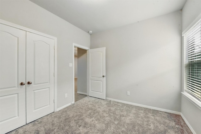 25707 Hickory Pecan Trl, Tomball, TX 77375 - unfurnished bedroom featuring carpet, baseboards, and a closet