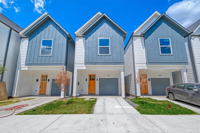2105 Sam Wilson St Unit C, Houston, TX 77020 - view of front of house featuring board and batten siding, an attached garage, and concrete driveway