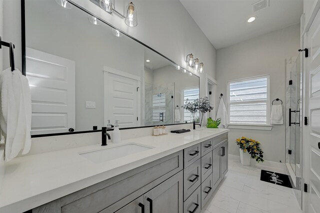 2105 Sam Wilson St Unit C, Houston, TX 77020 - bathroom with double vanity, a shower stall, marble finish floors, recessed lighting, and baseboards