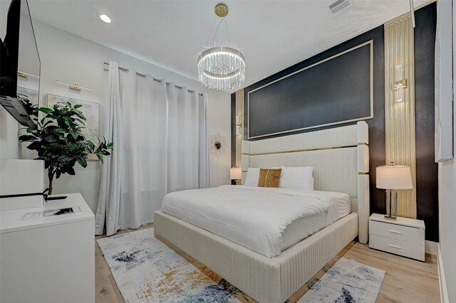 2105 Sam Wilson St Unit C, Houston, TX 77020 - bedroom with a chandelier, light wood-style floors, and recessed lighting