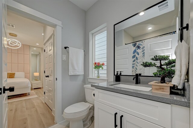 2105 Sam Wilson St Unit C, Houston, TX 77020 - full bathroom with vanity, wood finished floors, toilet, and recessed lighting