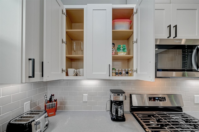 2105 Sam Wilson St Unit C, Houston, TX 77020 - kitchen featuring appliances with stainless steel finishes, open shelves, and white cabinetry