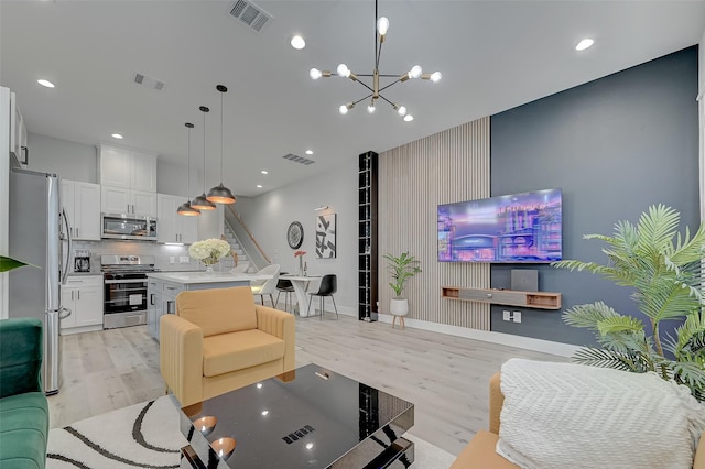 2105 Sam Wilson St Unit C, Houston, TX 77020 - living room featuring light wood-type flooring, baseboards, a chandelier, stairs, and recessed lighting