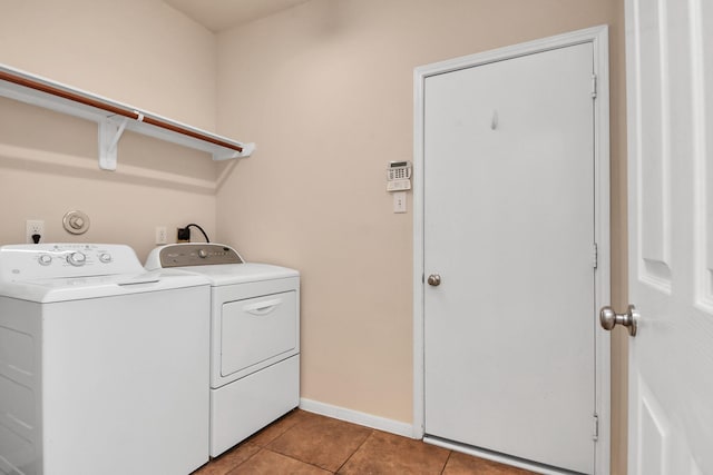 14311 Lakepointe Bend Ln, Cypress, TX 77429 - laundry area featuring washing machine and dryer, light tile patterned floors, and baseboards