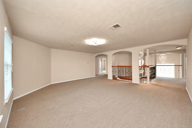14311 Lakepointe Bend Ln, Cypress, TX 77429 - carpeted empty room with arched walkways, a textured ceiling, and baseboards