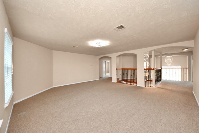14311 Lakepointe Bend Ln, Cypress, TX 77429 - carpeted empty room with arched walkways, a textured ceiling, and baseboards