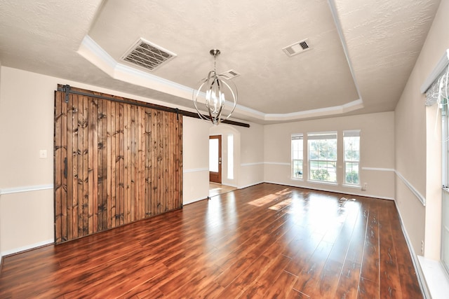 14311 Lakepointe Bend Ln, Cypress, TX 77429 - empty room with a tray ceiling, wood finished floors, a chandelier, arched walkways, and baseboards