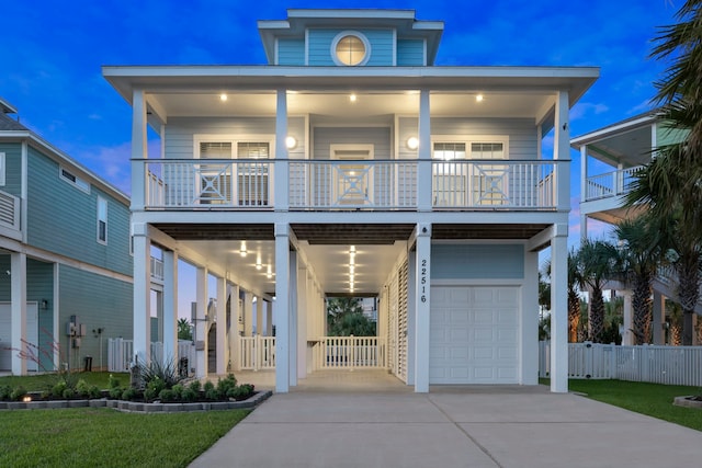 22516 Bay Point Dr, Galveston, TX 77554 - beach home featuring a garage, concrete driveway, and a balcony