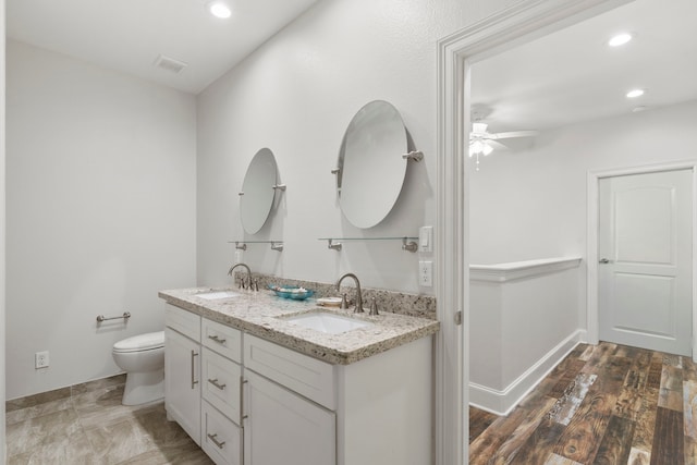 22516 Bay Point Dr, Galveston, TX 77554 - bathroom with double vanity, ceiling fan, toilet, and recessed lighting