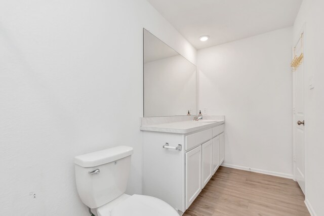 18110 Mendocino Ridge Ln, Hockley, TX 77447 - bathroom with vanity, toilet, wood finished floors, and baseboards