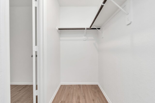 18110 Mendocino Ridge Ln, Hockley, TX 77447 - walk in closet featuring wood finished floors