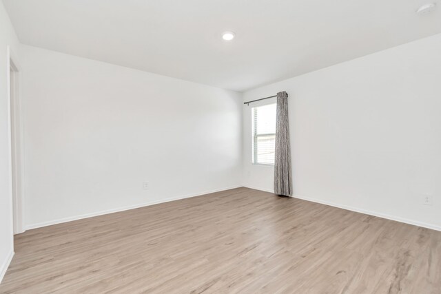 18110 Mendocino Ridge Ln, Hockley, TX 77447 - spare room featuring light wood finished floors, baseboards, and a smoke detector