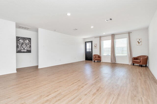 18110 Mendocino Ridge Ln, Hockley, TX 77447 - unfurnished living room with light wood finished floors and recessed lighting