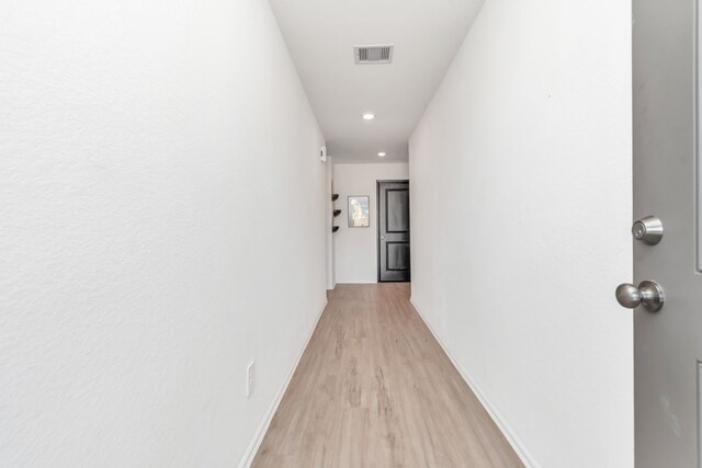 18110 Mendocino Ridge Ln, Hockley, TX 77447 - hallway with light wood finished floors, baseboards, and recessed lighting