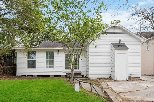 5004 Park Dr, Houston, TX 77023 - back of property with a yard, a patio area, roof with shingles, and entry steps
