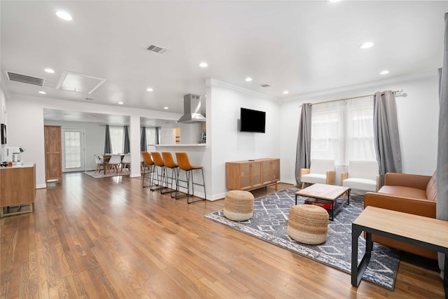5004 Park Dr, Houston, TX 77023 - living area featuring wood finished floors, crown molding, and recessed lighting