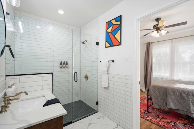5004 Park Dr, Houston, TX 77023 - ensuite bathroom with a shower stall, vanity, a ceiling fan, recessed lighting, and tile walls