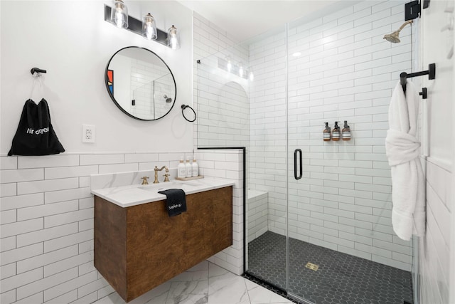 5004 Park Dr, Houston, TX 77023 - full bath with tile walls, marble look tiles, vanity, and a shower stall