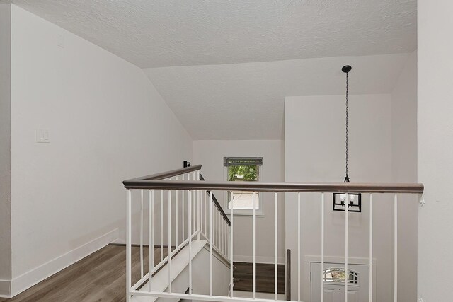 3 Meadow Beauty, The Woodlands, TX 77381 - stairway with wood finished floors, a textured ceiling, vaulted ceiling, and baseboards