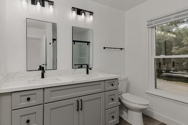 3 Meadow Beauty, The Woodlands, TX 77381 - full bath featuring double vanity, toilet, a shower with shower door, and wood finished floors