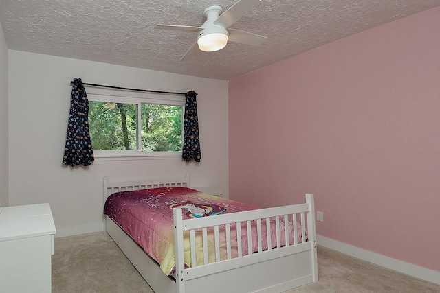 3 Meadow Beauty, The Woodlands, TX 77381 - carpeted bedroom featuring a textured ceiling, baseboards, ceiling fan, and radiator