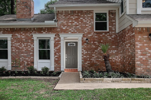 3 Meadow Beauty, The Woodlands, TX 77381 - property entrance with a shingled roof, a chimney, and brick siding