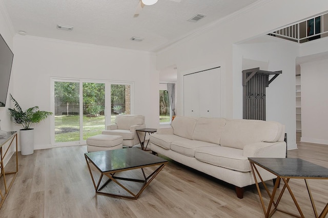3 Meadow Beauty, The Woodlands, TX 77381 - living room with light wood-style flooring, a ceiling fan, ornamental molding, and baseboards