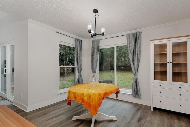3 Meadow Beauty, The Woodlands, TX 77381 - dining space featuring a textured ceiling, wood finished floors, crown molding, baseboards, and plenty of natural light