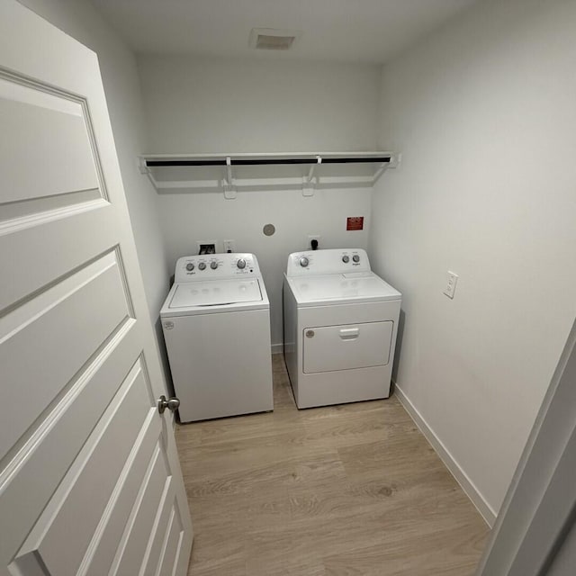 29919 Gallatin River Ln, Katy, TX 77494 - washroom featuring washer and dryer, light wood finished floors, and baseboards