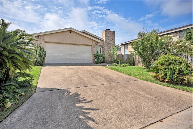 5927 Maco St, Galveston, TX 77551 - view of front facade featuring concrete driveway and an attached garage