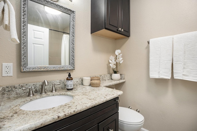 5927 Maco St, Galveston, TX 77551 - bathroom featuring vanity, toilet, and curtained shower