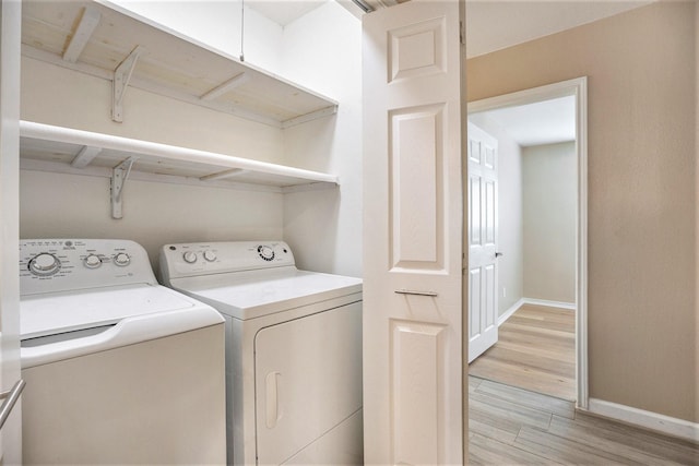 5927 Maco St, Galveston, TX 77551 - washroom featuring washer and dryer, light wood-type flooring, and baseboards