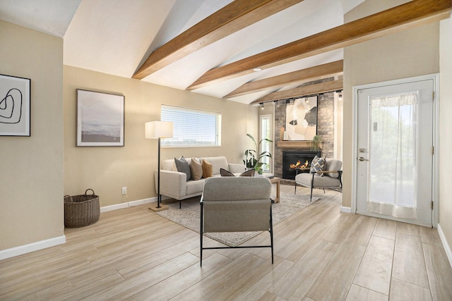 5927 Maco St, Galveston, TX 77551 - living room with a fireplace, baseboards, and light wood-style floors