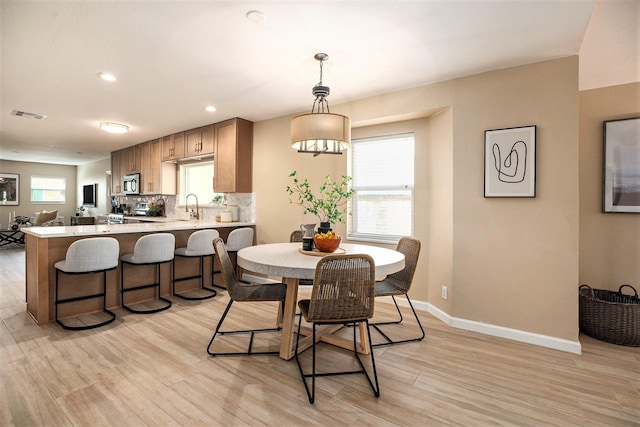5927 Maco St, Galveston, TX 77551 - dining area featuring light wood finished floors, baseboards, and recessed lighting