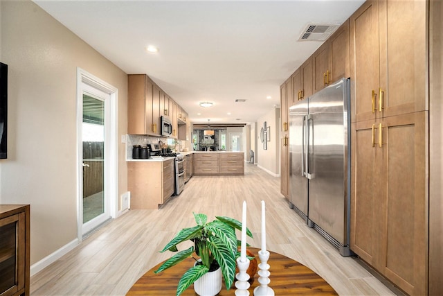 5927 Maco St, Galveston, TX 77551 - kitchen with stainless steel appliances, light wood-style floors, light countertops, baseboards, and recessed lighting
