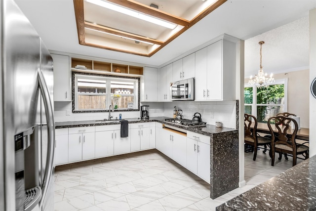 5330 Pine Cliff Dr, Houston, TX 77084 - kitchen featuring stainless steel appliances, a sink, light marble finish floors, and a chandelier