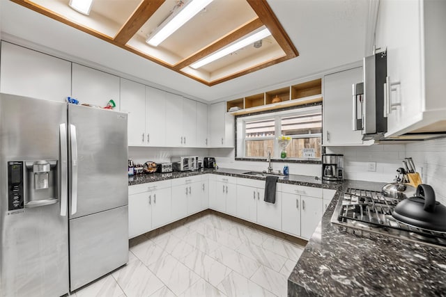5330 Pine Cliff Dr, Houston, TX 77084 - kitchen with appliances with stainless steel finishes, a sink, white cabinets, and light marble finish floors