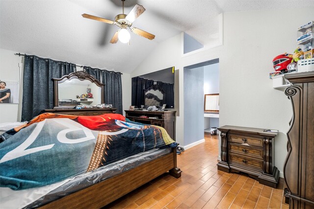 5330 Pine Cliff Dr, Houston, TX 77084 - bedroom with lofted ceiling, baseboards, wood finished floors, a ceiling fan, and a textured ceiling