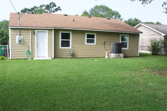 3922 Alsace St, Houston, TX 77021 - back of house with central air condition unit, a lawn, and a shingled roof