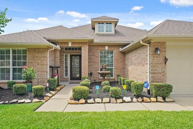 20719 Kerby Pl, Cypress, TX 77433 - doorway to property with an attached garage, brick siding, and roof with shingles