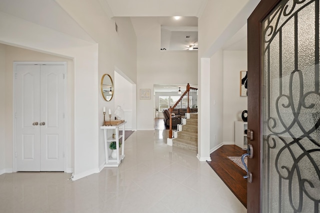 20719 Kerby Pl, Cypress, TX 77433 - foyer featuring baseboards, light tile patterned flooring, stairway, and ceiling fan