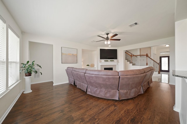 20719 Kerby Pl, Cypress, TX 77433 - living room with dark wood-type flooring, a fireplace, stairway, ceiling fan, and baseboards