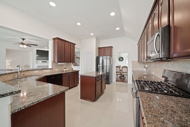 20719 Kerby Pl, Cypress, TX 77433 - kitchen featuring appliances with stainless steel finishes, a sink, vaulted ceiling, dark stone countertops, and tasteful backsplash
